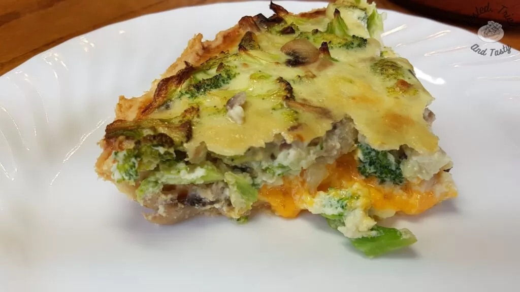 Broccoli quiche recipe on a white plate.