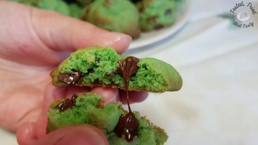 Gooey melted chocolate chips in a green cookie.