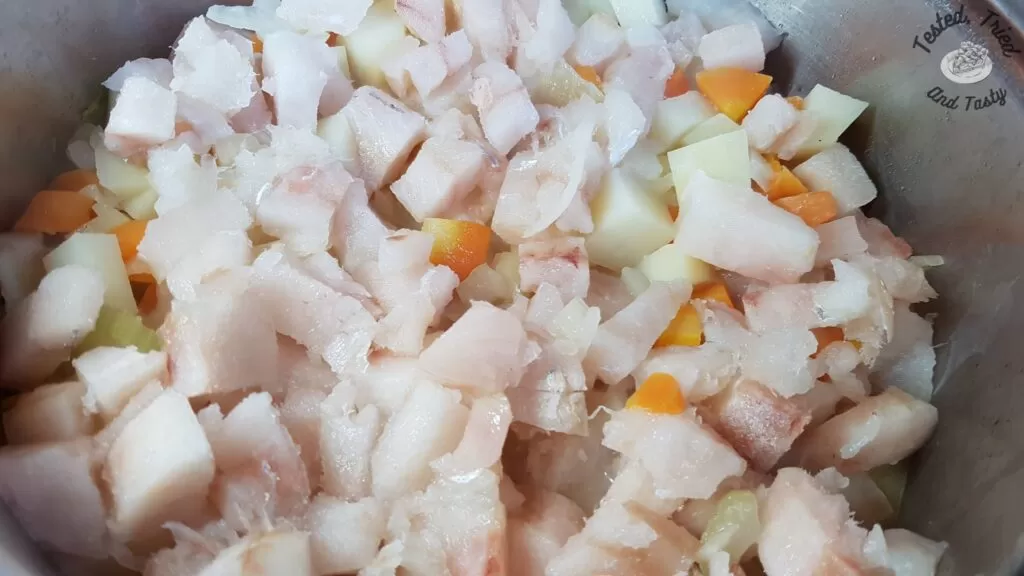 Fish chunks added to the carrots, potatoes, salt, pepper, onions and celery in a large saucepan.