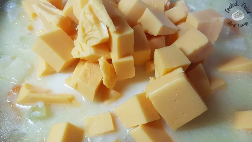 Velveeta chunks added to the fish soup.