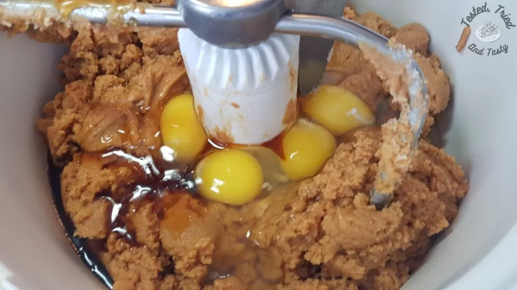Eggs, vanilla, and peanut butter added to the sugar and butter mixture.