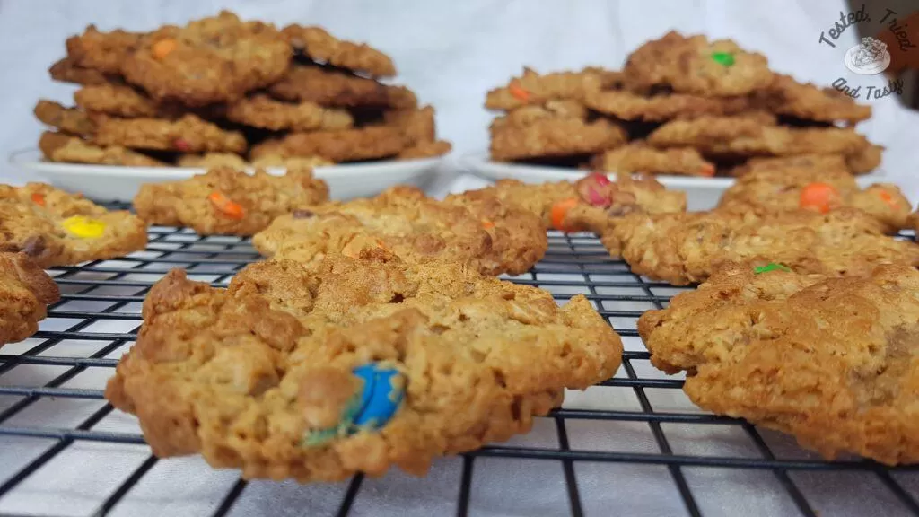 Peanut butter, oatmeal chocolate chip cookies on a wire cooling rack.