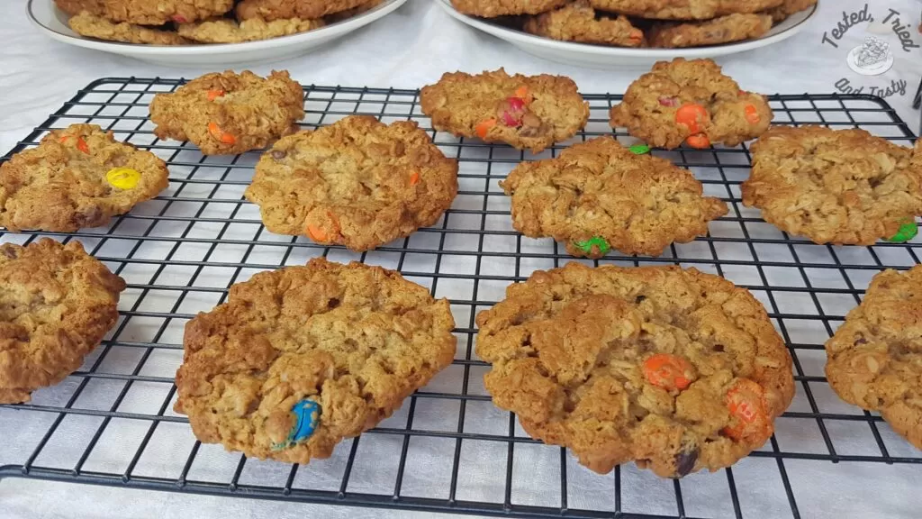 Monster cookies on a wire cooling rack.