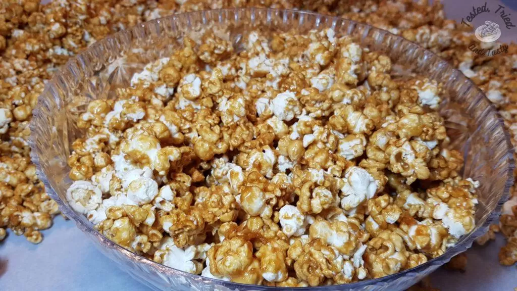 Caramel popcorn in a clear bowl.