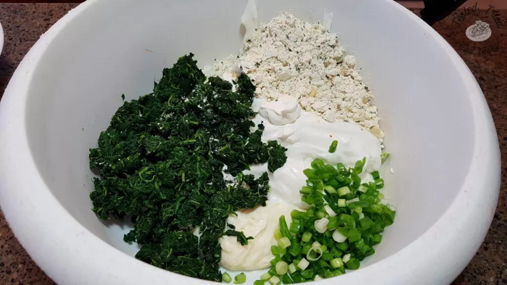 All ingredients for spinach appetizer in a white bowl.