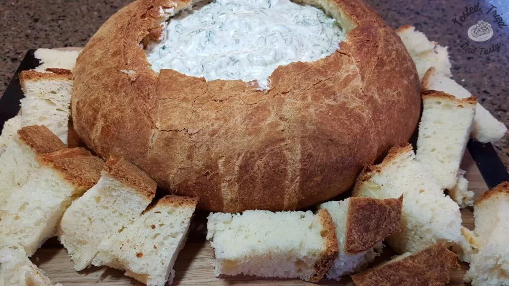 Spinach dip in a sourdough bread loaf.