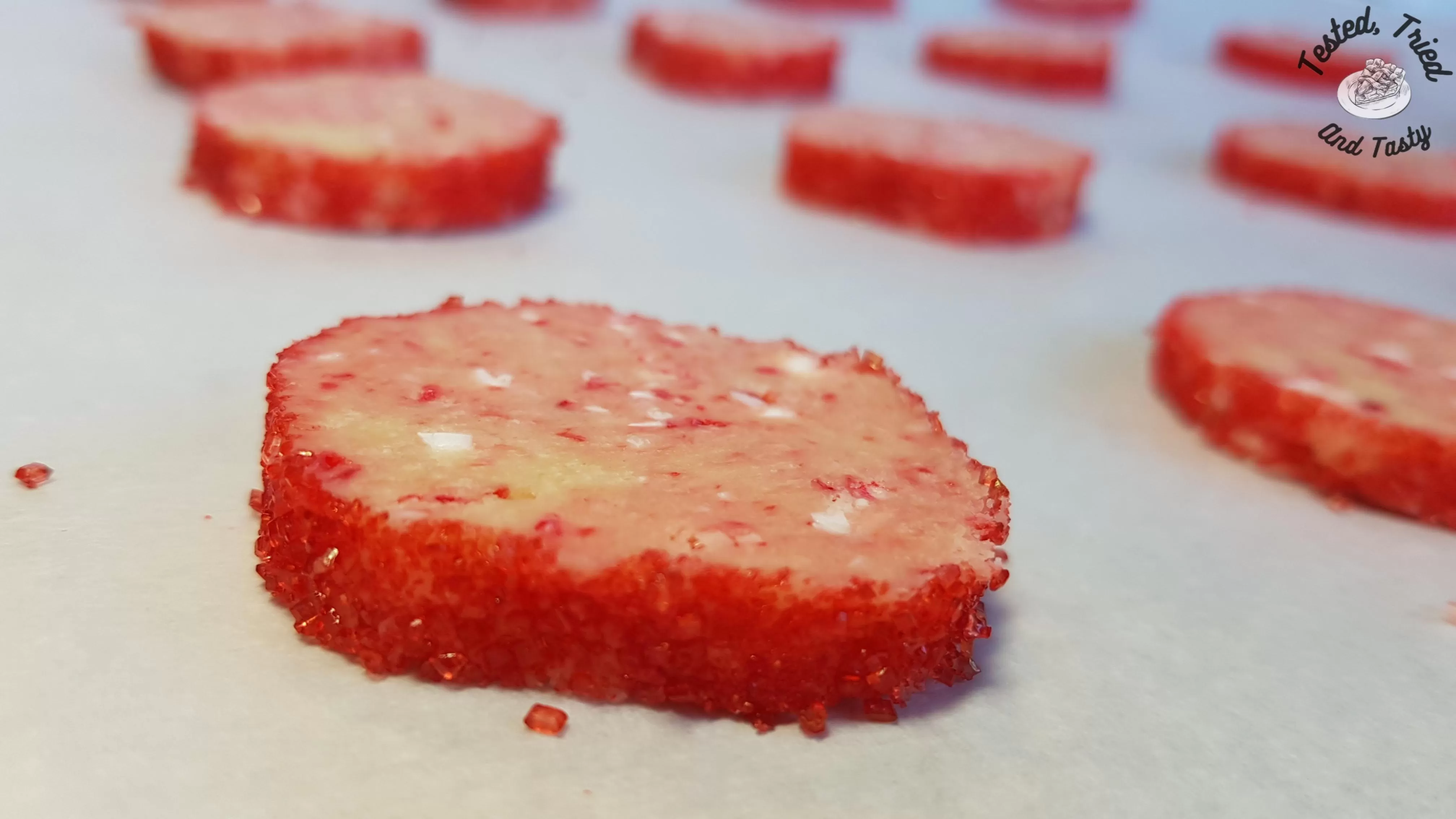 Candy cane icebox cookies on parchment paper lined baking sheet.
