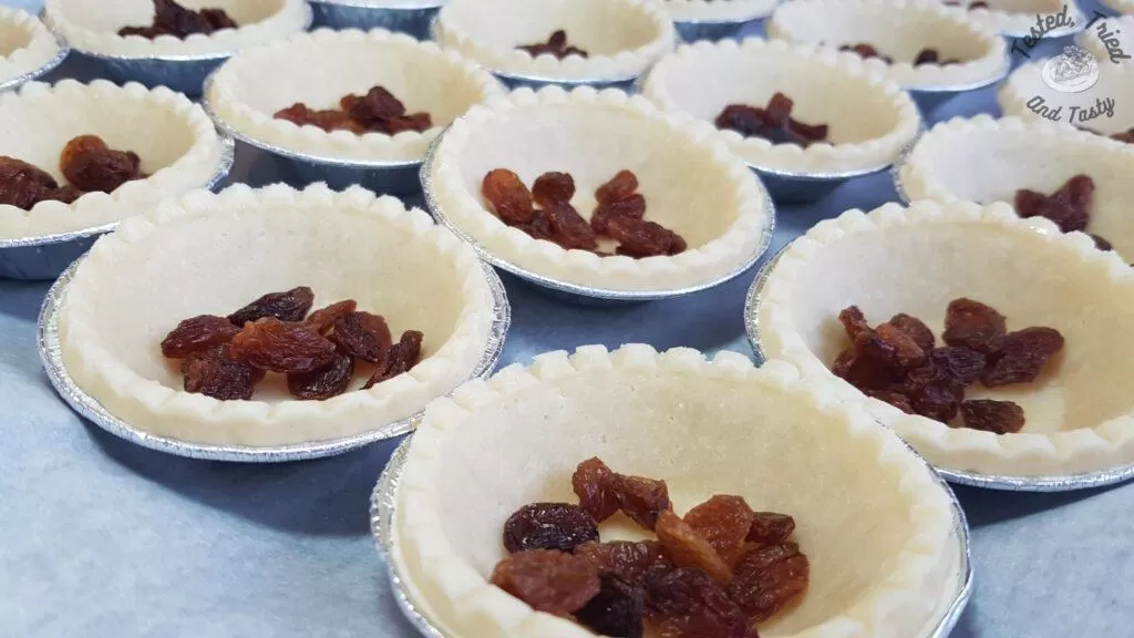 Raisins placed in tart shells.
