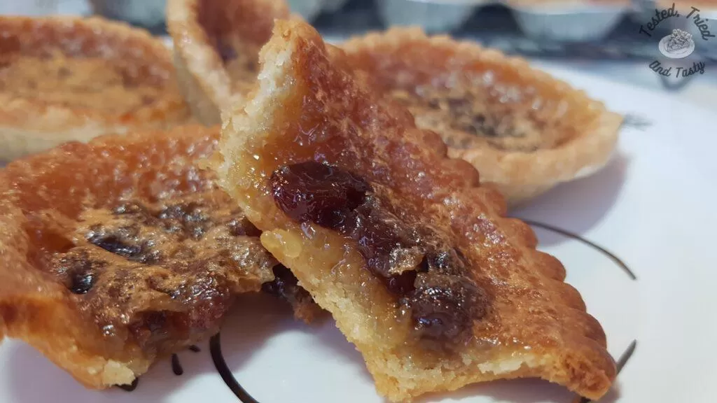 Butter tarts on a christmas plate.