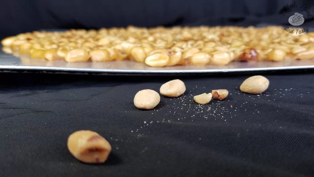 Candy brittle cooling on a baking sheet.
