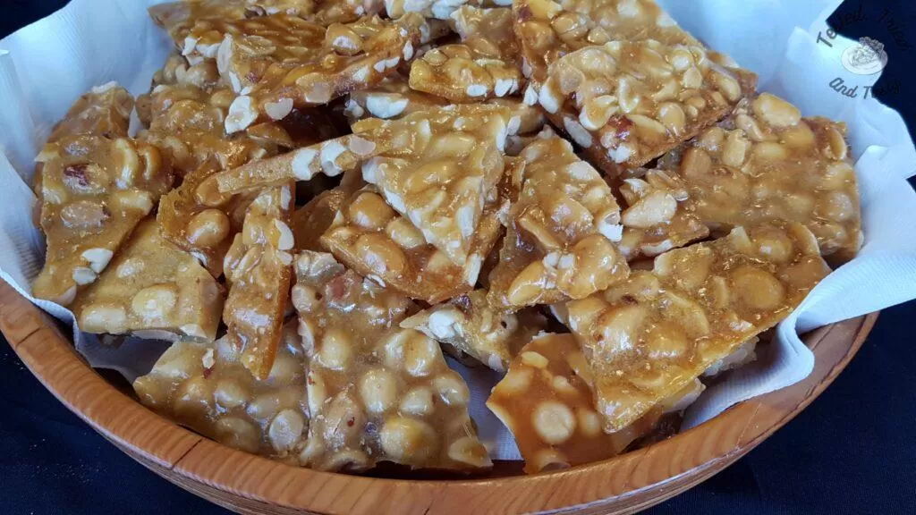 Peanut brittle in a wooden bowl.