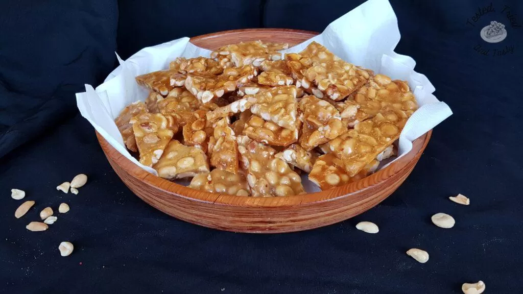 Peanut brittle in a wooden bowl.