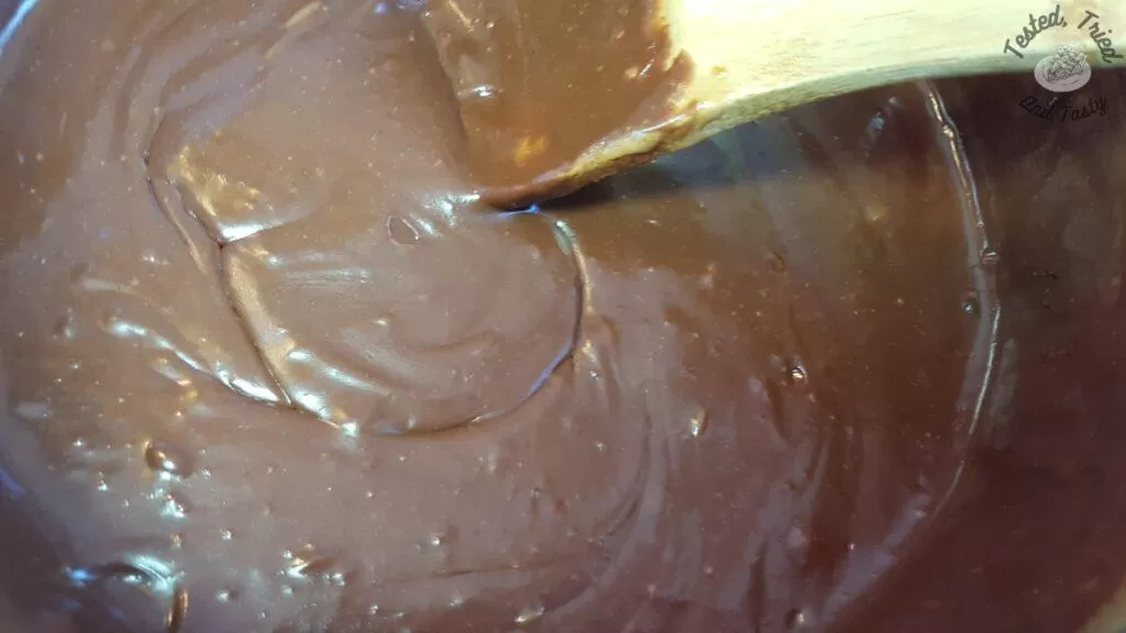 Mixing the chocolate chips and the vanilla into the chocolate fudge.