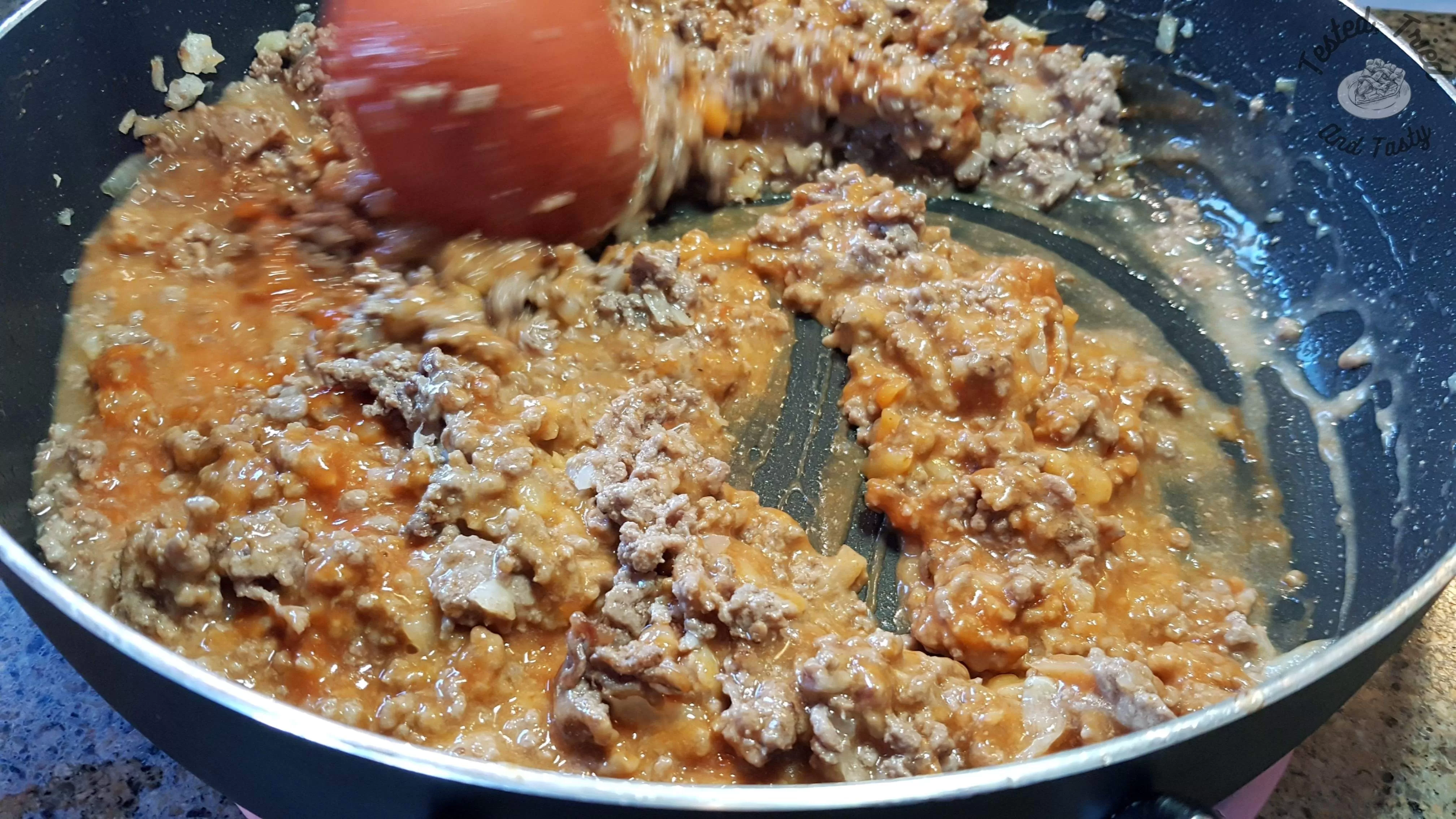 Sloppy Joes Recipe being mixed in a large saucepan.