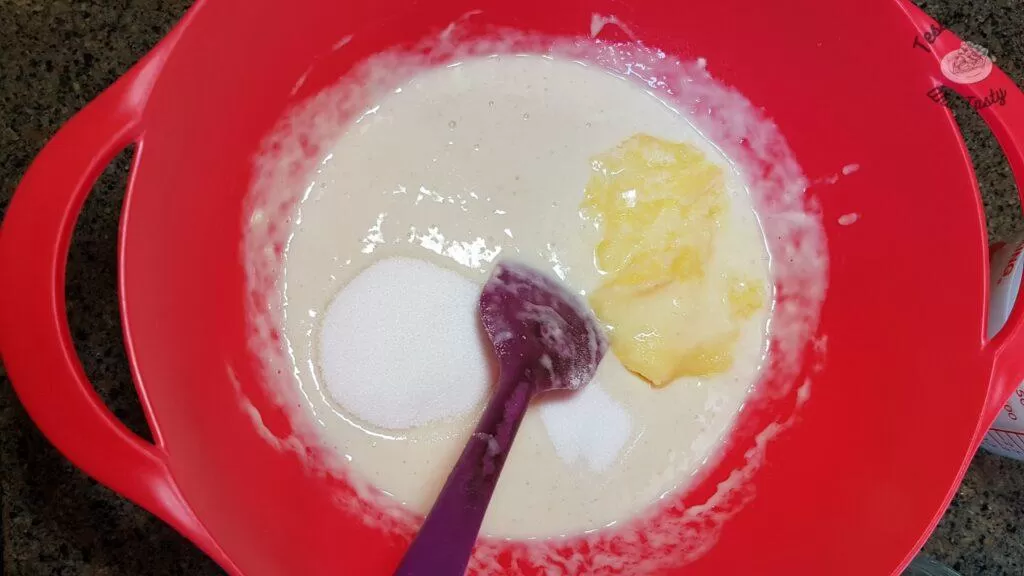 Mixing the butter,salt, sugar, milk and water into the sourdough starter.