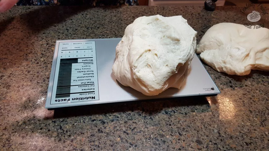 weighing the raw dough before forming loaves.