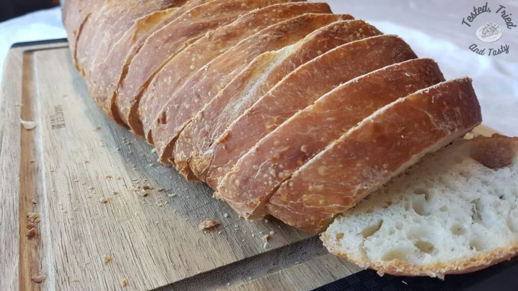 Sourdough bread for beginners sliced on a wooden cutting board.