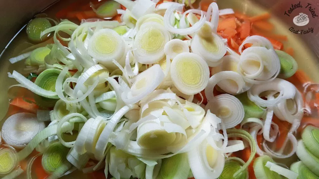 Leeks, baby corn, and carrots in chicken broth.