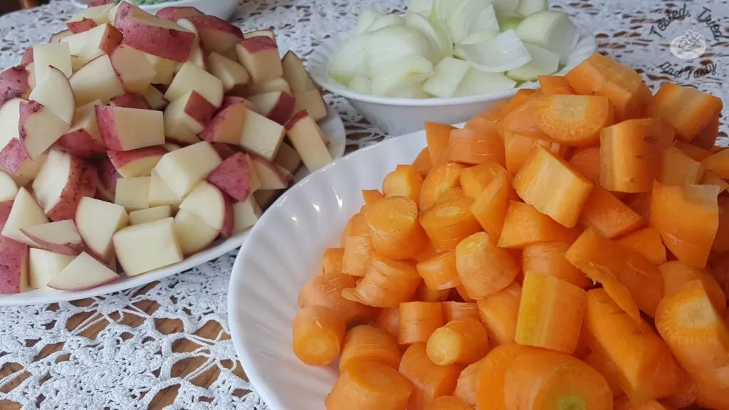 Carrots, potatoes and onions cut into bite sized pieces.