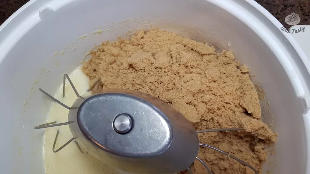 Adding the sugar to the beaten eggs.