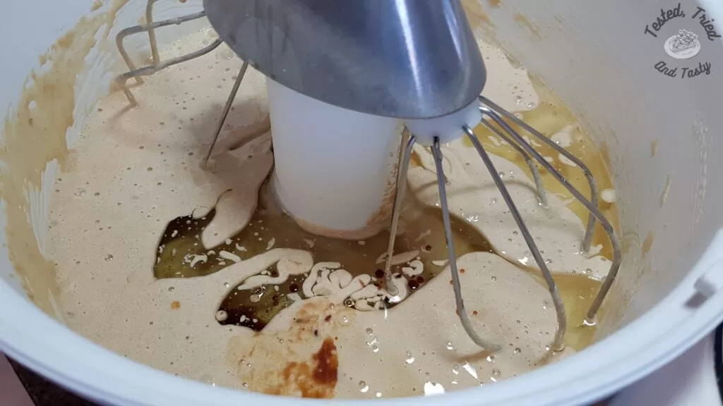 Adding the oil to the liquid ingredients in the bosch mixer.