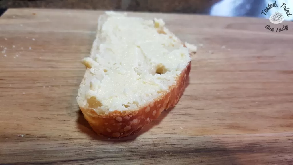 Garlic butter spread on a slice of homemade sourdough bread.