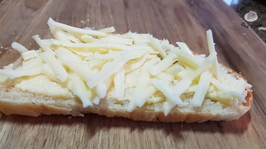 Mozzarella cheese on top of garlic butter on french bread.