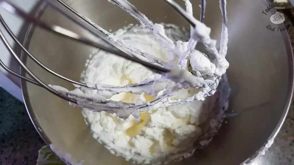 Whipping cream whipped in a stand mixer.