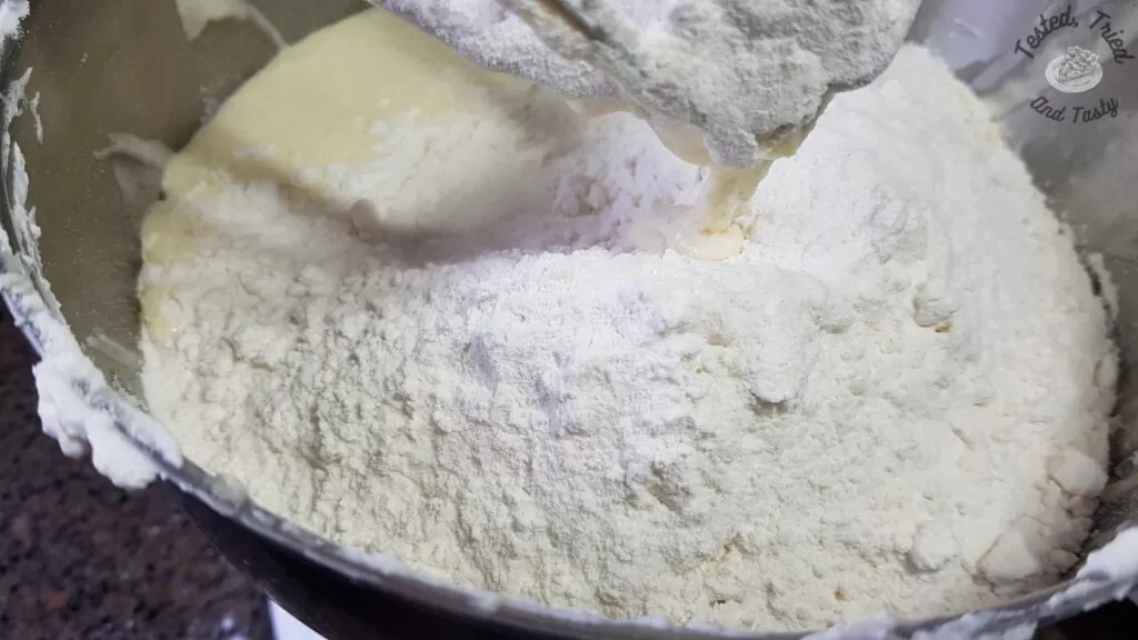 Adding the flour to the liquid ingredients for Fattigman.