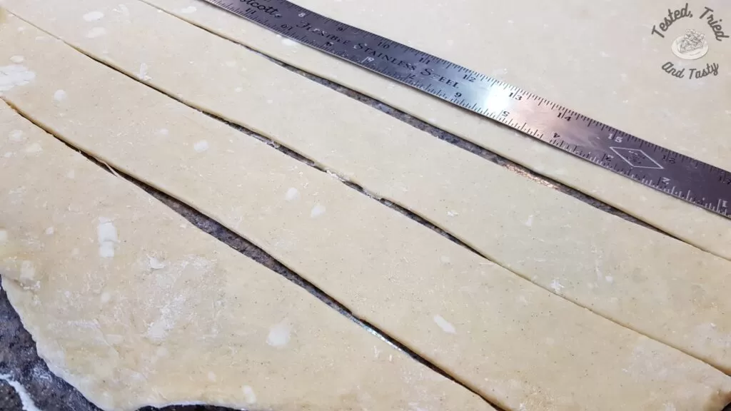 Cutting the dough in strips for Fattigman.