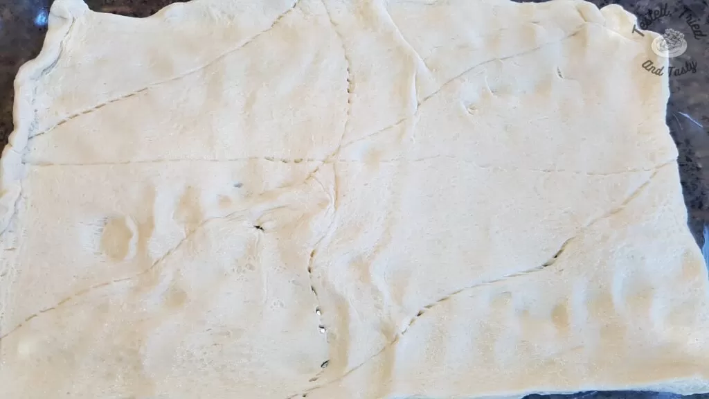 Pillsbury crescent rolls on a baking sheet.